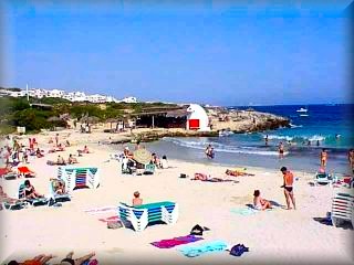 La hermosa playa de Binibeca, es y a sido uno de los emblemas para el reclamo turístico de la isla de Menorca dispone de todos los servicios de plata y un bosque de pinos al fondo de la playa